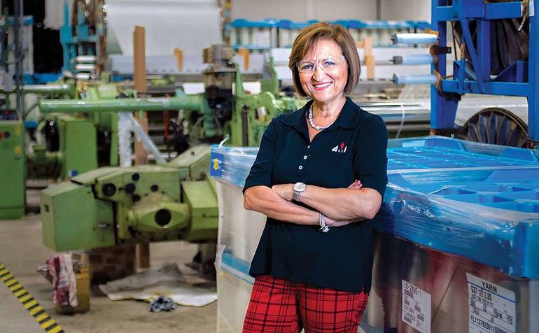 person smiling in factory 