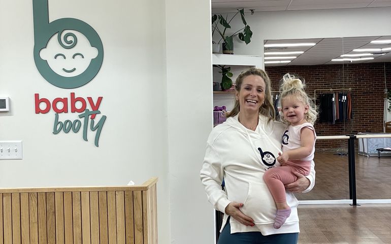 2 people smiling with sign