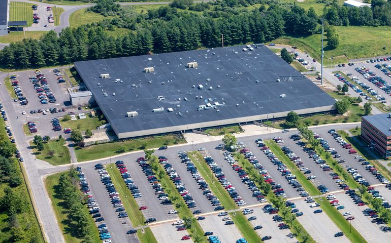 aerial of big building and parking lot with cars