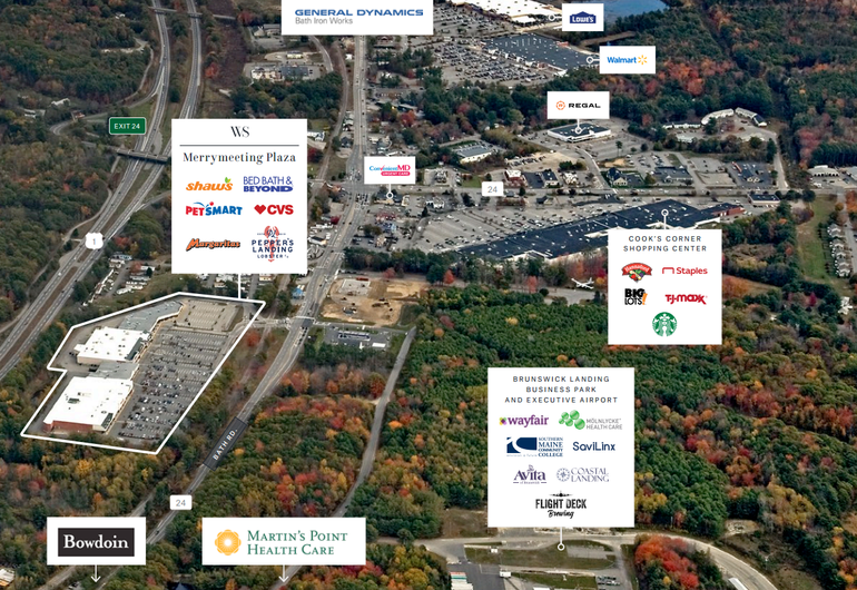 aerial of stores and woods with signs