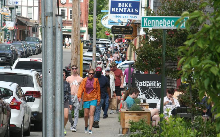 crowds and signs on sidewalk