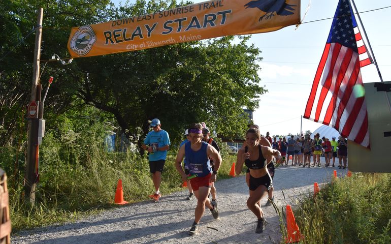 runners at start line with flag