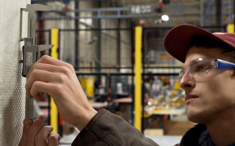 person in safety glasses with machinery