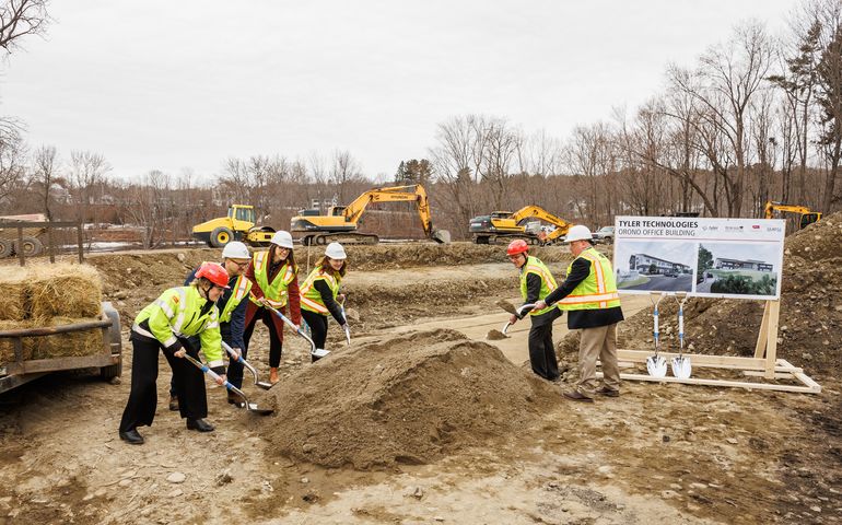 people with shovels and dirt mound