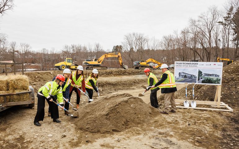 people with shovels and dirt mound