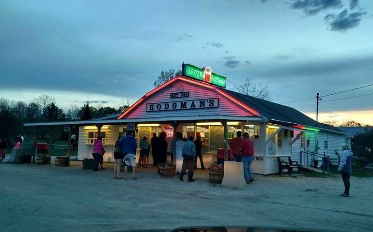 people outside frozen custard stand