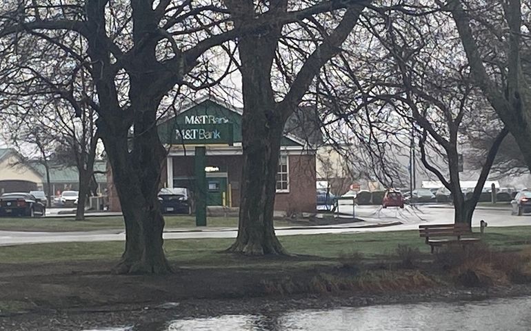 Bank branch building behind a pond