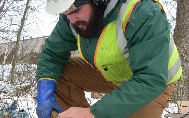 person in hardhat kneeling