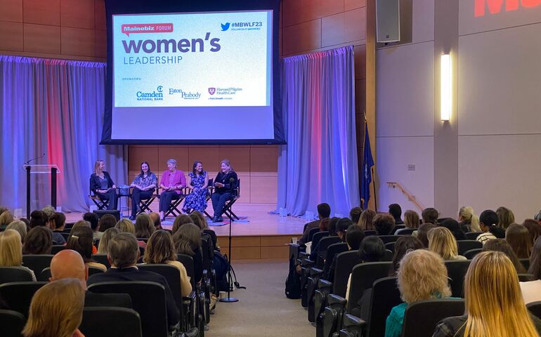 women on stage at event