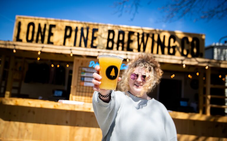 Person holding up a beer 