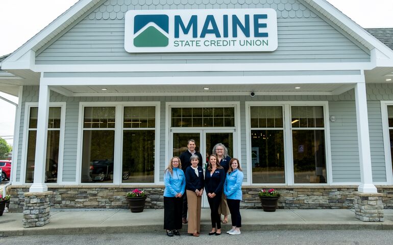 People in front of credit union branch 