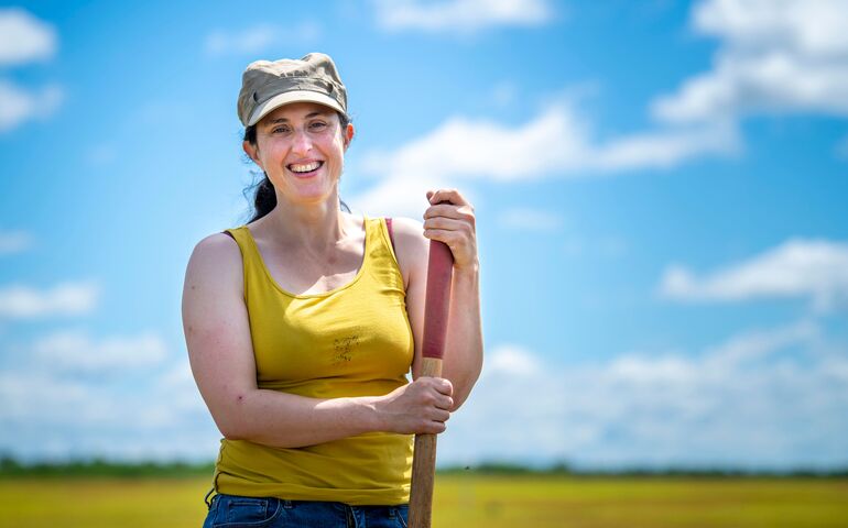 person outside in cap and yellow tank top