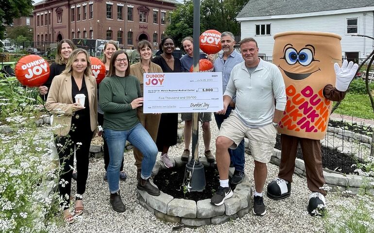 people with Dunkin mascot