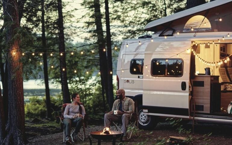 2 people sitting with RV
