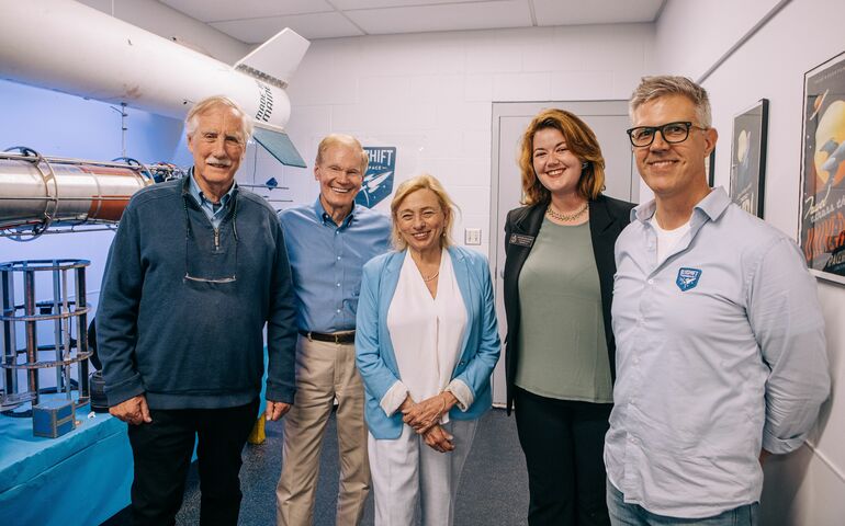 5 people in a line smiling