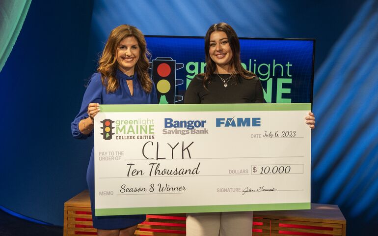 Two women holding prize check 