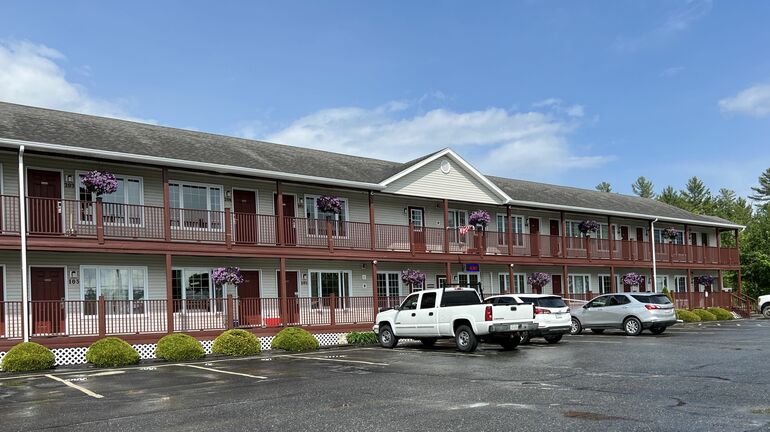motel exterior with parked vehicles