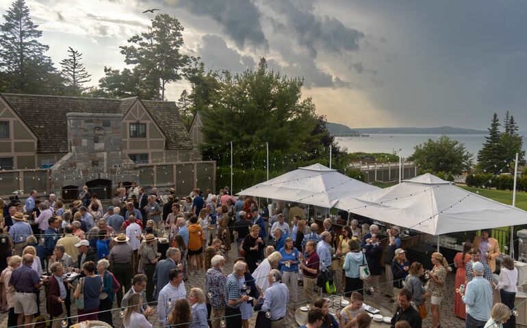 crowd of people with tent and sky