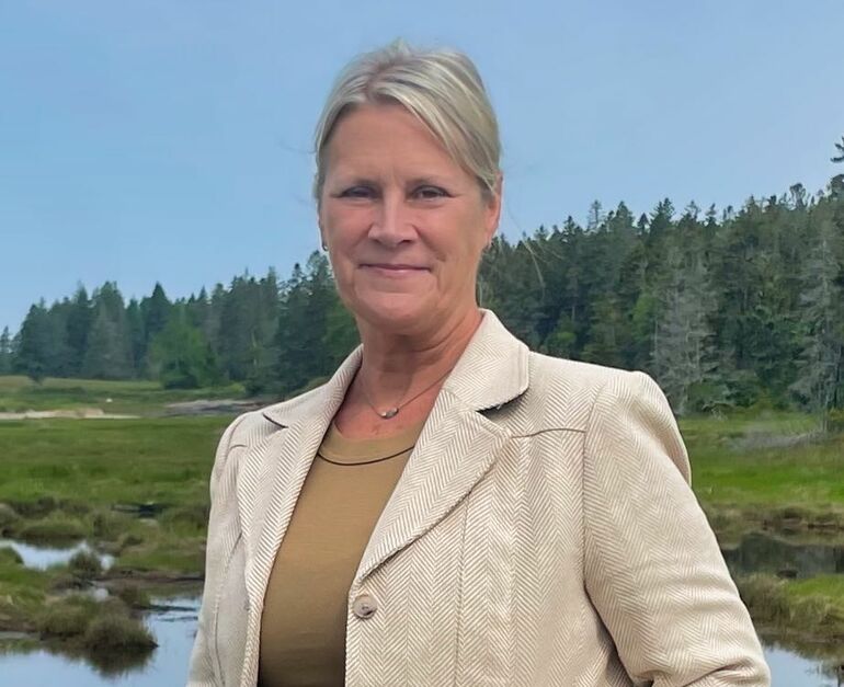 person by the water smiling