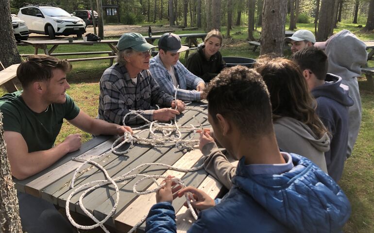 people around picnic table wtih rope