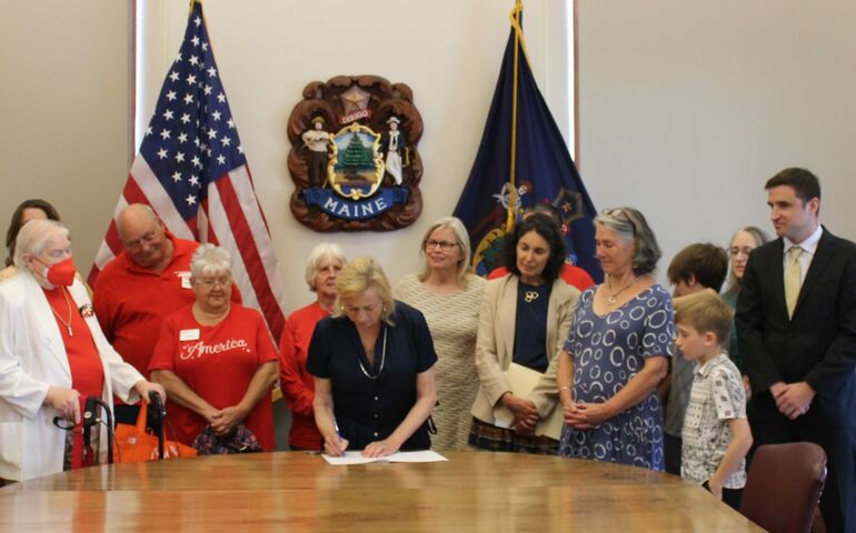 group of people standing at table