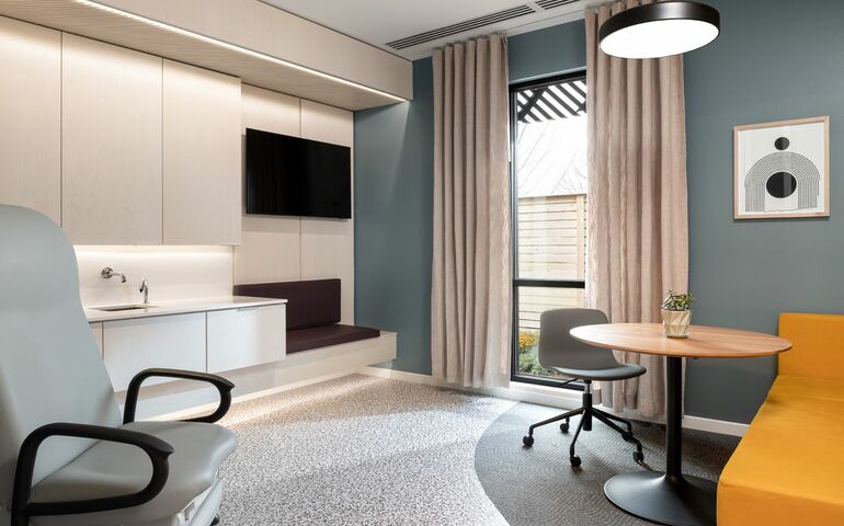 room with chairs table counters cabinets window