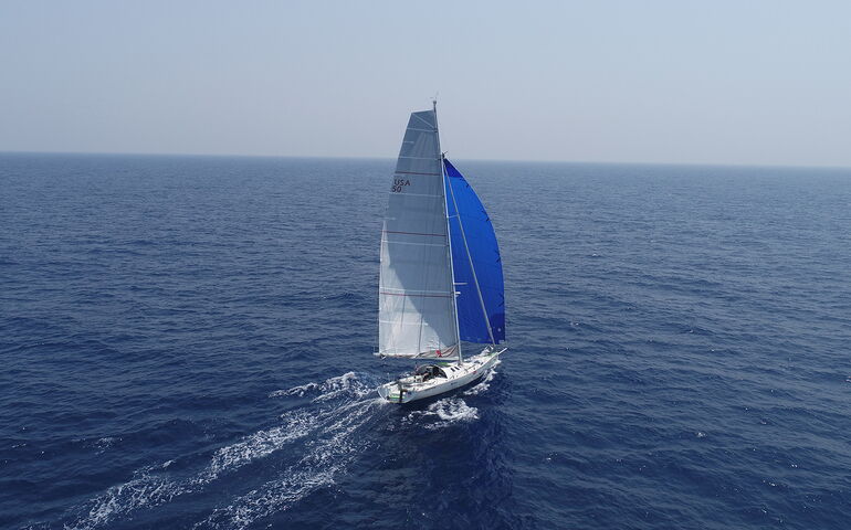 boat with sail on ocean