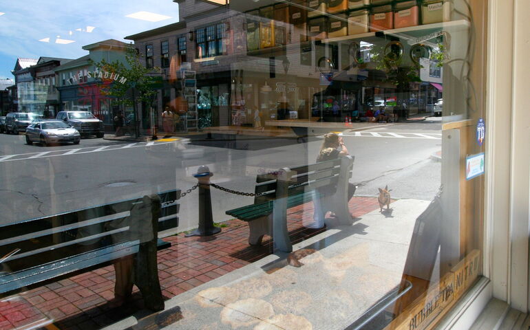 reflection with park benches and sidewalk