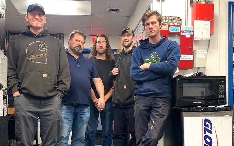 5 people standing indoors
