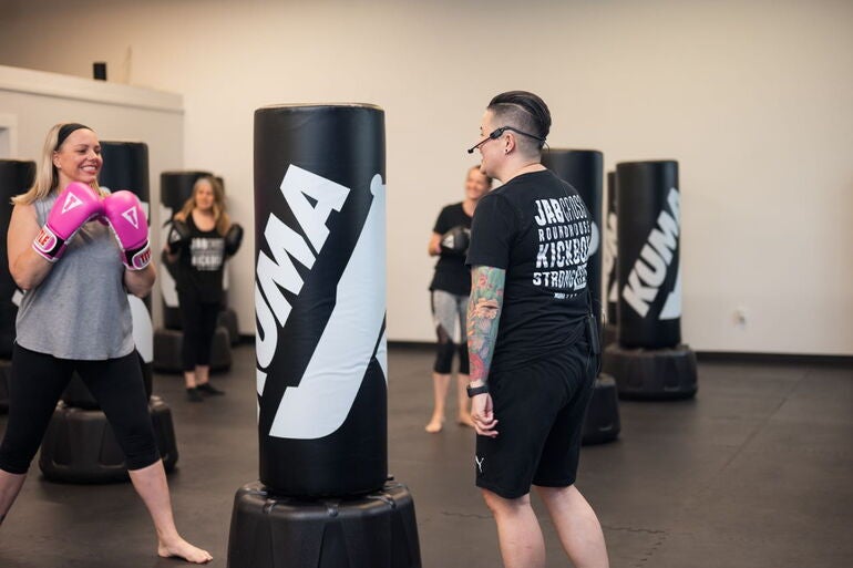 4 people with sparring bags