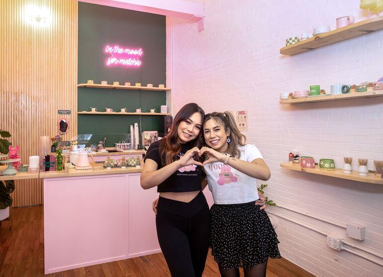 2 people hugging and making heart sign with hands