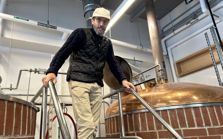 Man in a brewery on steps 
