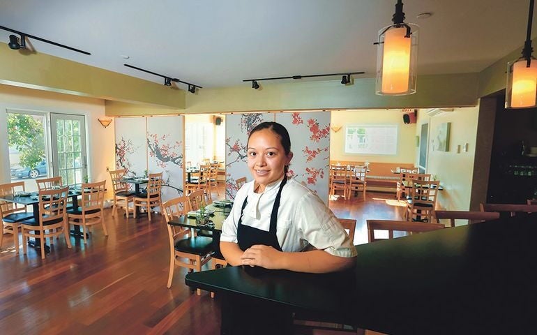 person with elbow on bar in restaurant