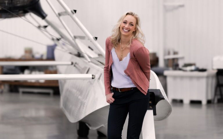 person leaning against big device in warehouse