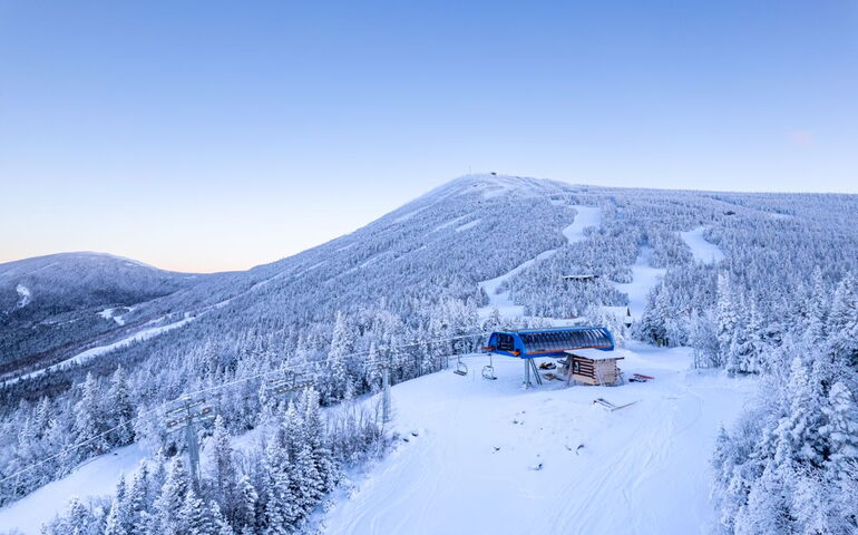 snowy hill with trails and chairlift