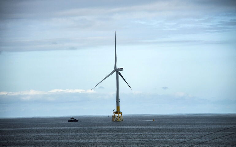 windmill and boat in ocean