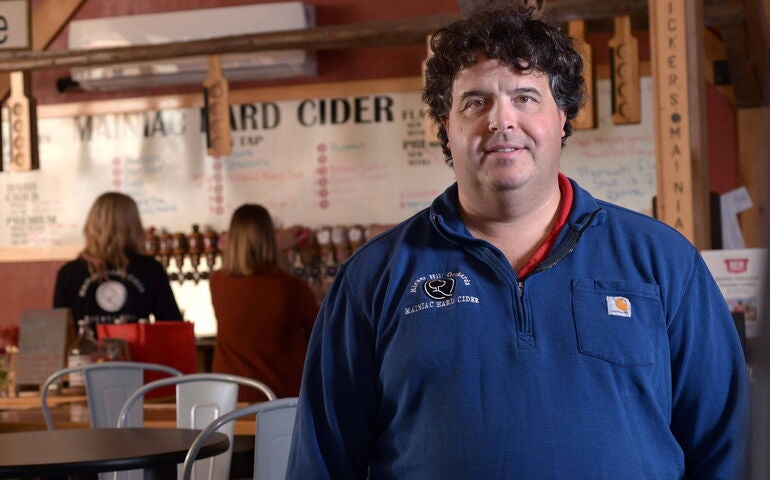 person in blue jacket inside bar