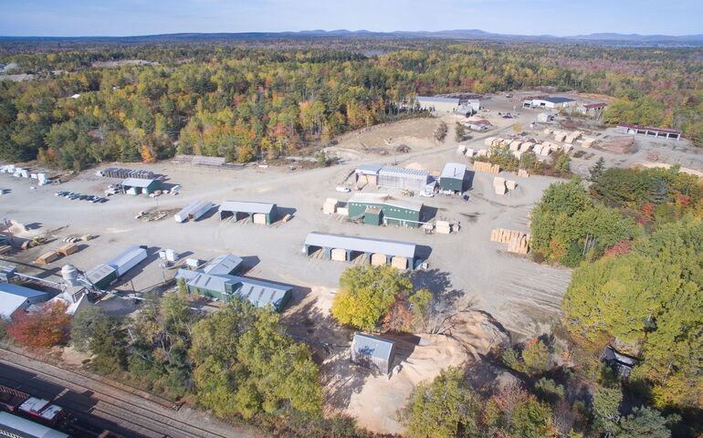 aerial view of buildings and woods