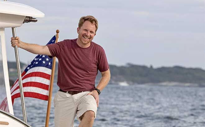 person in brown t-shirt and white shorts on boat