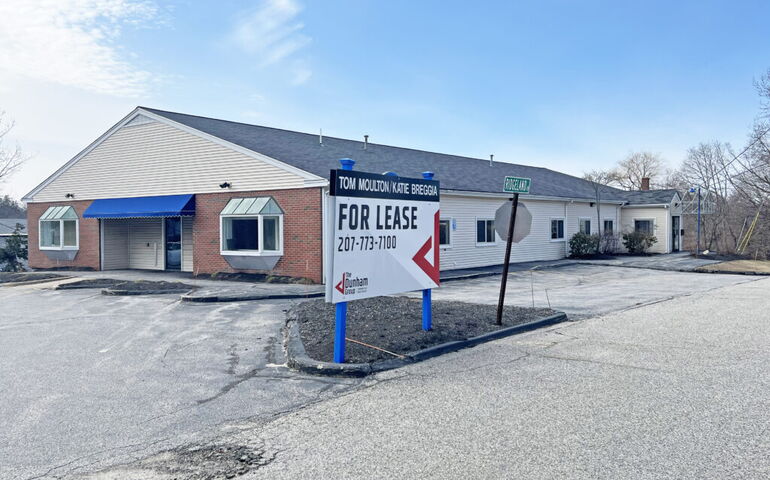 building with parking lot and sign