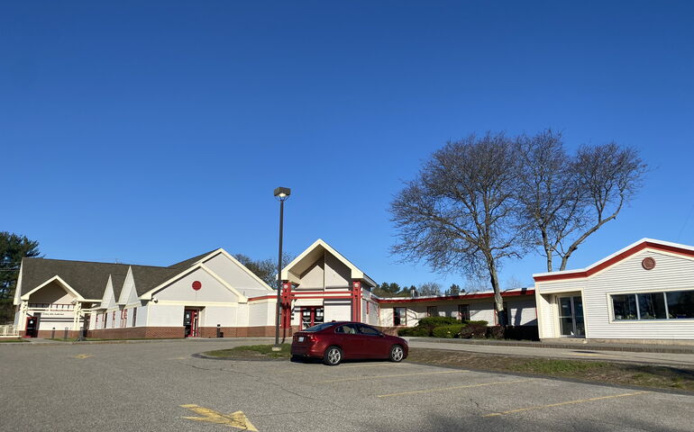 building, parking lot, and car