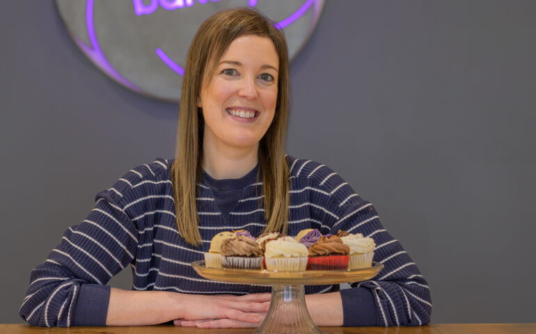 Woman with platter of cupcakes 