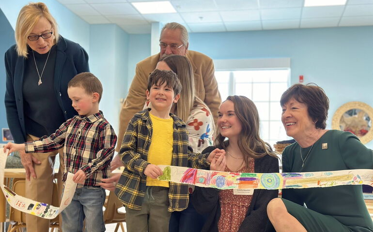 people lined up with paper ribbon