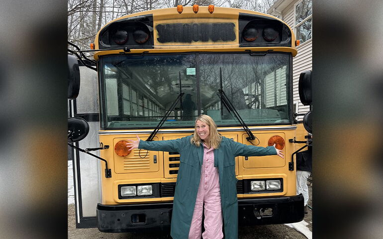Amy VanHaren of pumpspotting in front of a school bus 