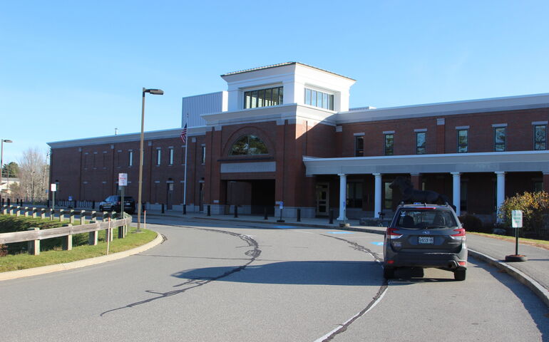Hampden Academy's exterior is a typical brick building with white columns.