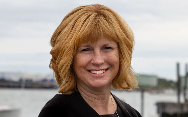 A broker with Malone stands near a harbor.