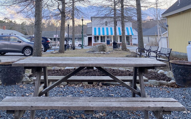 A very small park with a picnic bench in Ellsworth.