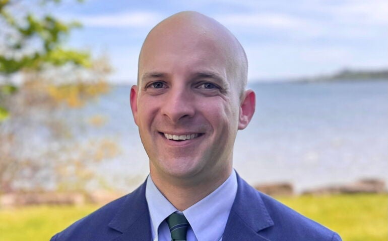 Re/Max's third owner stands outside.