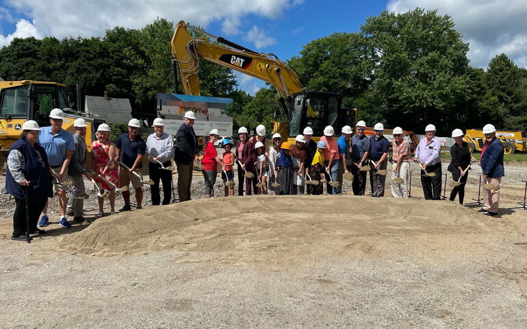 In Auburn, a line of people with shovels pose for a groundbreaking of the PAL center.