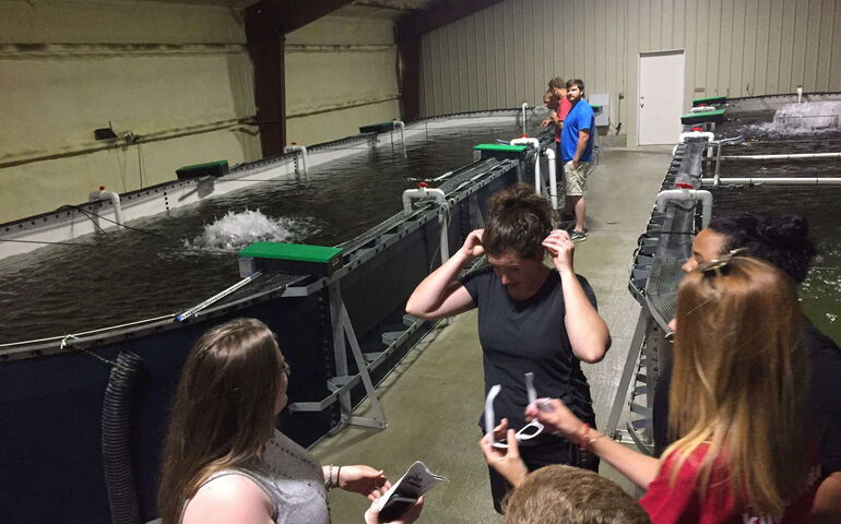 A group of people assemble at the Mi’kmaq fish hatchery.